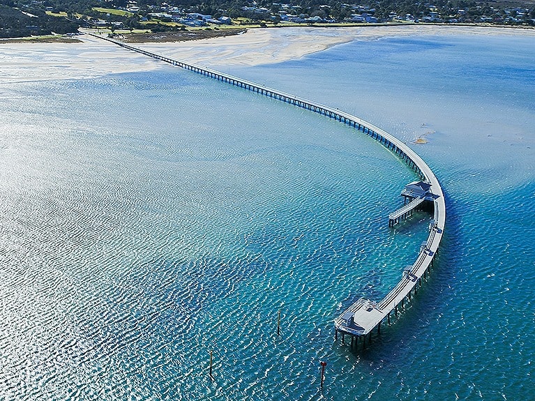 The Long Jetty stretches 800 metres out to the waters of Corner Inlet. Once used as a base for industrial vessels, the jetty is now used solely for pedestrians